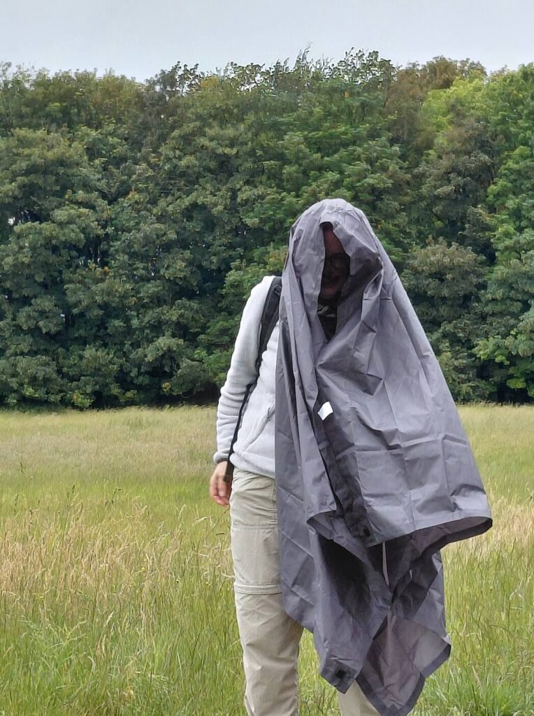 Caroline draped in a large sheet in an attempt to keep dry in the Cotswolds